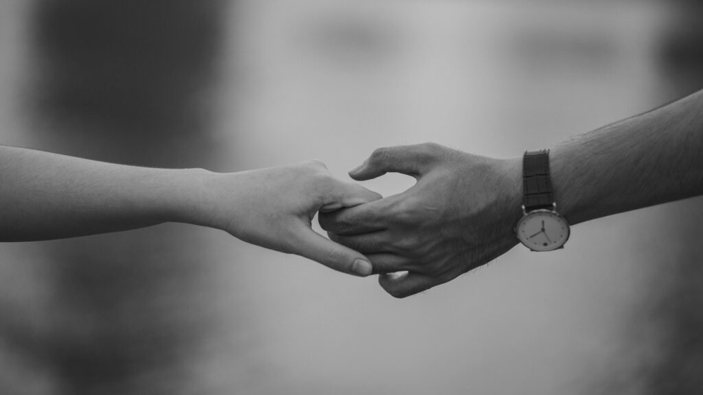 অপেক্ষা of two hands holding, symbolizing love and connection.