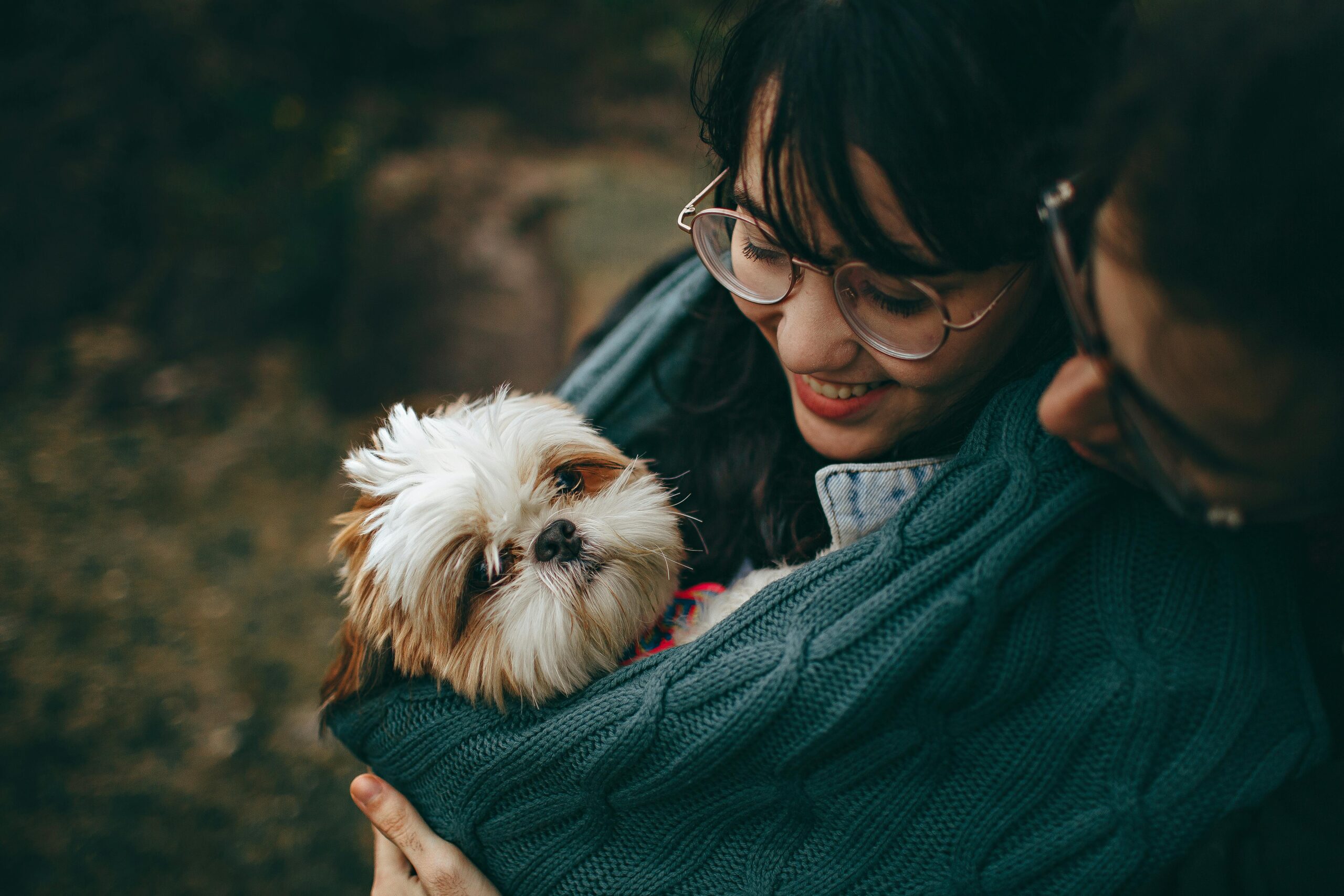 A woman lovingly cuddles her dog.